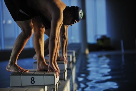 start position race concept with fit swimmer on swimming poolの写真素材