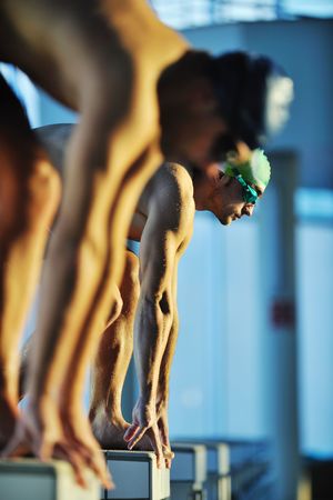 start position race concept with fit swimmer on swimming poolの写真素材