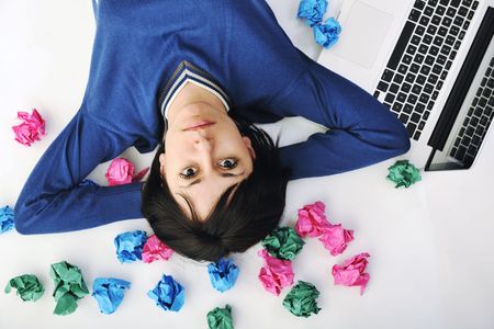 young beautiful brunette student woman working on laptop computer and finding solutionsの写真素材