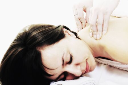 young woman relax and enjoy back massage treatment isolated on whiteの写真素材