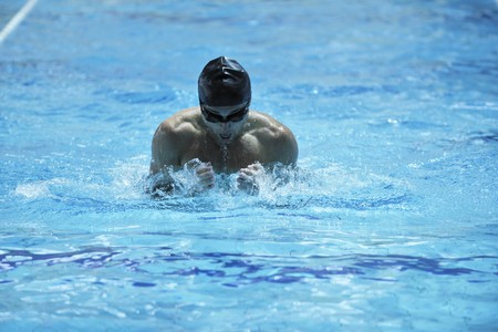 young healthy with muscular body man swim on swimming pool and representing healthy and recreation conceptの写真素材