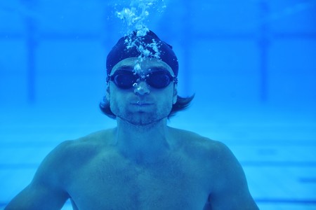 undervater shoot of swimming pool with good looking young swimmer の写真素材