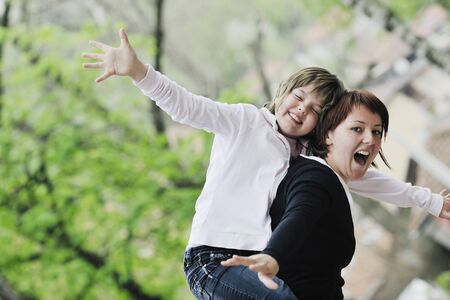 happy oung mother and daughter have fun outdoor の写真素材