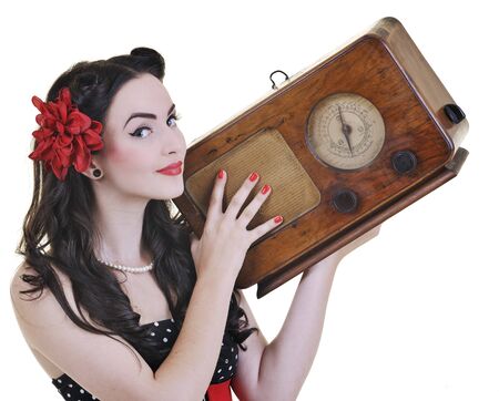 pretty girl listening music on radio isolated on white in studioの写真素材