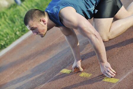 healthy young man at start line ready for run race and win
