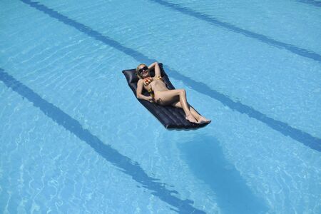 beautiful young woman enjoy sun and coctail dring relaxing and have fun at siwmming pool