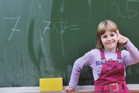 happy school girl on math classes finding solution and solving problems