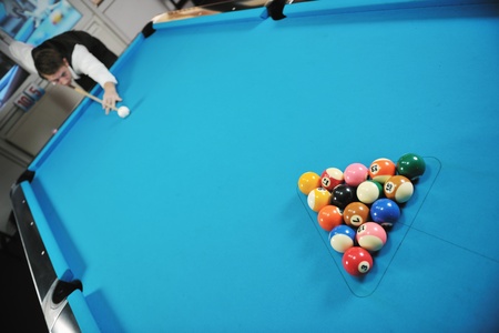 young pro billiard player finding best solution and right angle at billard or snooker pool sport ...