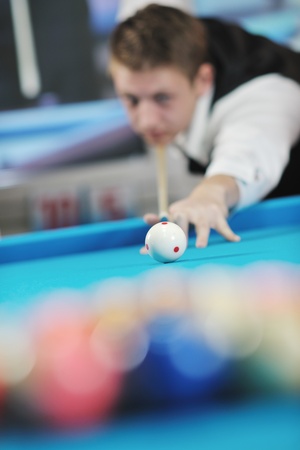 young pro billiard player finding best solution and right angle at billard or snooker pool sport  game の写真素材