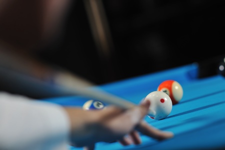 young pro billiard player finding best solution and right angle at billard or snooker pool sport ...