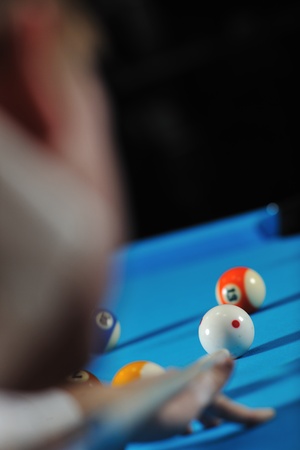 young pro billiard player finding best solution and right angle at billard or snooker pool sport ...