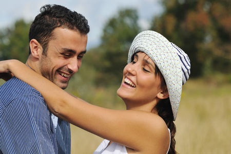 happy young couple have romantic time outdoor while smiling and hugの写真素材