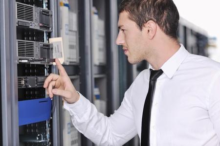 young handsome business man  engeneer in datacenter server room 