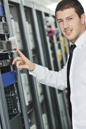young handsome business man  engeneer in datacenter server room 