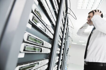 business man in network server room have problems and looking for  disaster solution 