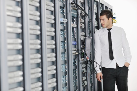 young handsome business man it  engeneer in datacenter server room
