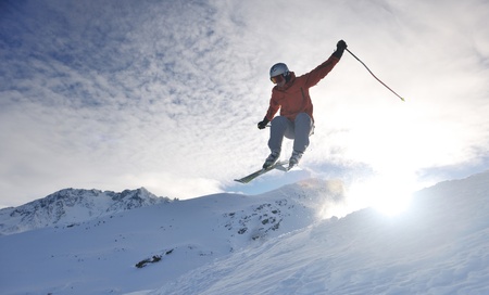 young athlete man have fun during skiing sport on hi mountain slopes at winter seasson and sunny dayの写真素材