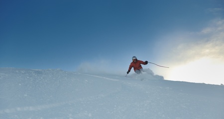 young athlete man have fun during skiing sport on hi mountain slopes at winter seasson and sunny dayの写真素材