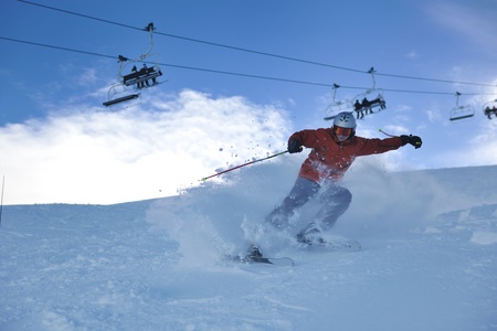 young athlete man have fun during skiing sport on hi mountain slopes at winter seasson and sunny dayの写真素材