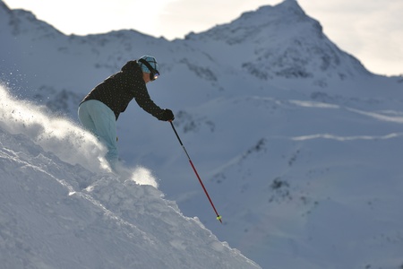 young healthy woman skiing on fresh snow at winter season in france alpsの写真素材