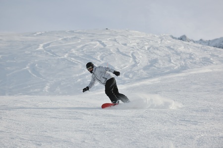 young athlete man have fun during skiing sport on hi mountain slopes at winter seasson and sunny dayの写真素材