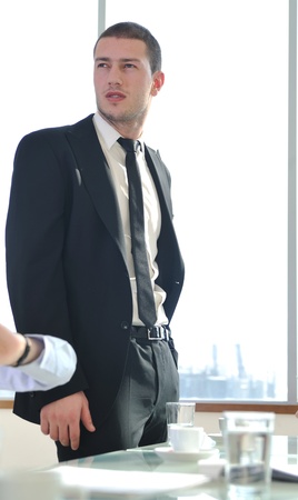 young business man lawyer with laptop alone in big bright   conference roomの写真素材