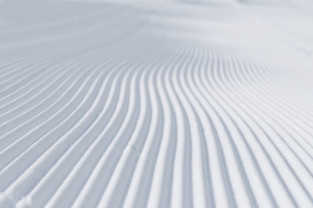 tracks on ski slopes in snow at beautiful sunny  winter day with blue skyの写真素材