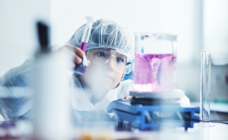 cute little male child have experiment with test tubes in bright modern lab