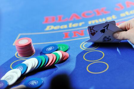 woman play black jack card game in casino on blue tableのeditorial素材