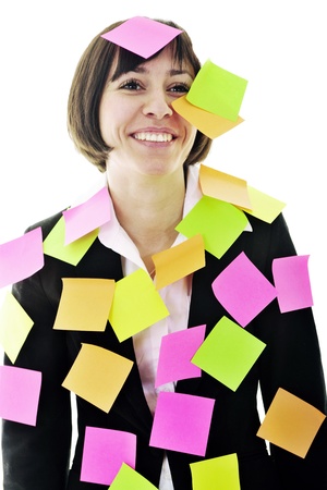 one frustrated young business woman with many of post it representing concept memory and frustration on workの写真素材