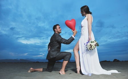 happy just married young couple celebrating and have fun at beautiful beach sunsetの写真素材