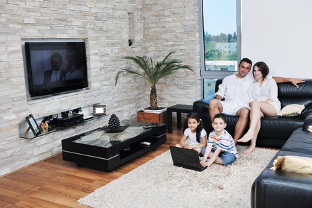 happy young family have fun and working on laptop at modern  home livingroom indoorの写真素材