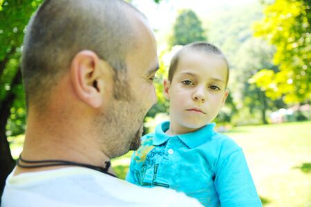 family father and son have fun at park on summer season and representing happines conceptの写真素材