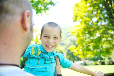 family father and son have fun at park on summer season and representing happines conceptの写真素材