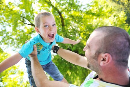 family father and son have fun at park on summer season and representing happines conceptの写真素材
