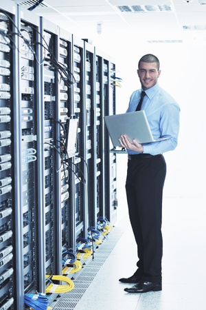 young engeneer business man with thin modern aluminium laptop in network server roomの写真素材
