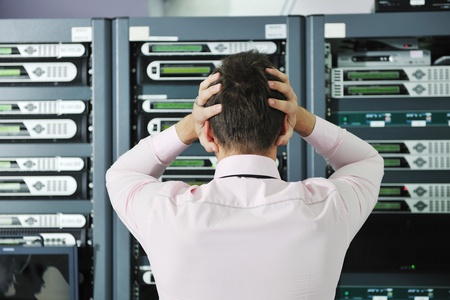 it business man in network server room have problems and looking for  disaster situation  solutionの写真素材