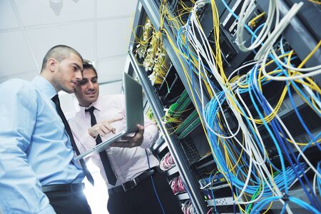 group of young business people it engineer in network server room solving problems and give help and supportの写真素材