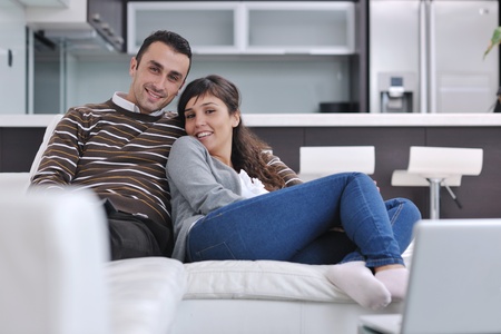 happy young couple relax at modern home living room indoorの写真素材