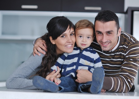happy young family have fun and relaxing at new home with bright furnitureの写真素材