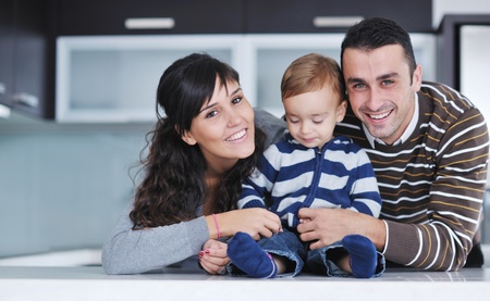 happy young family have fun and relaxing at new home with bright furnitureの写真素材