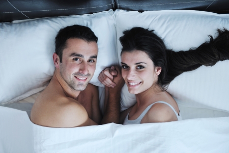 happy young healthy people  couple have good time in their bedroom make love and sleepの写真素材