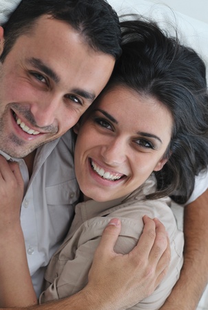happy young couple relax at modern home living room indoorの写真素材
