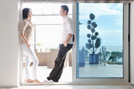 happy young couple relax at modern home living room indoorの写真素材