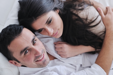 happy young couple relax at modern home living room indoorの写真素材