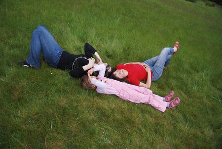 girls seat on grass  の写真素材