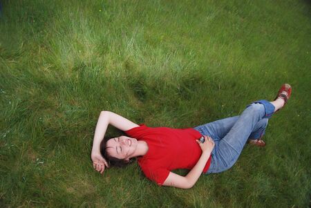 woman laying in grass  の写真素材
