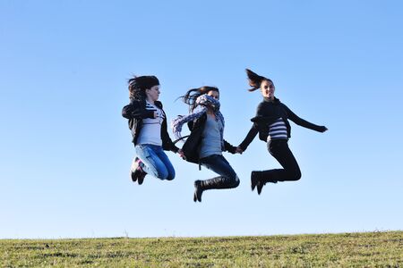 group of teen people woman  have fun outdoor with blue sky in backgroundの写真素材