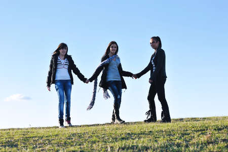 group of teen people woman  have fun outdoor with blue sky in backgroundの写真素材