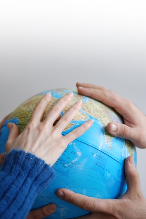 Teamwok concept with hands on globe                             (NIKON D80; 20.3.2007; 1/40 at f/2.8; ISO 400; white balance: Auto; focal length: 35 mm)の写真素材